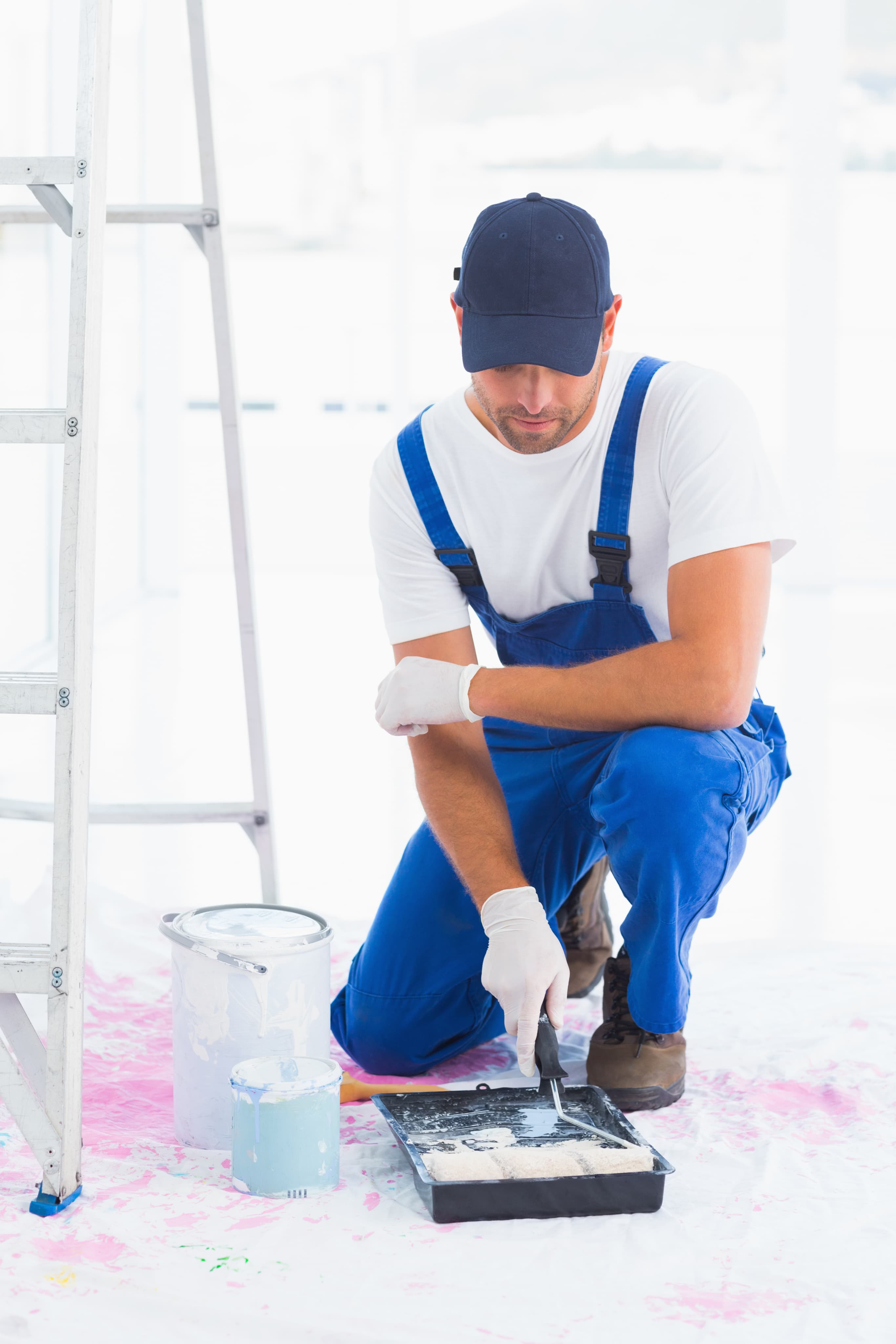 Worker in overalls ready for kitchen, bathroom, flooring, and window installation services at Aurora Home Hardware.