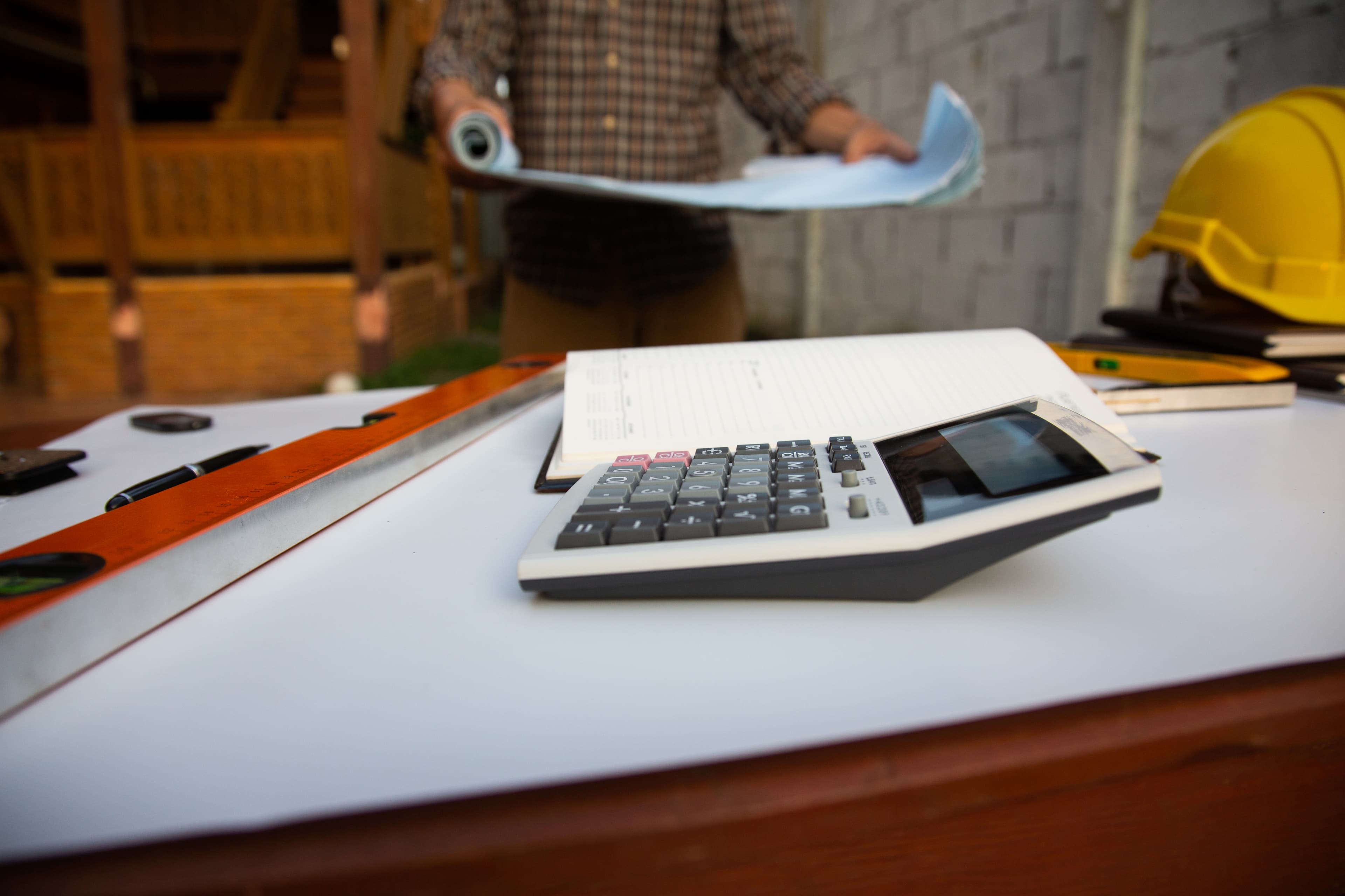 Calculator on a job site desk representing the invoicing digital feature available through Aurora Home Hardware Building Centre PRO Services.
