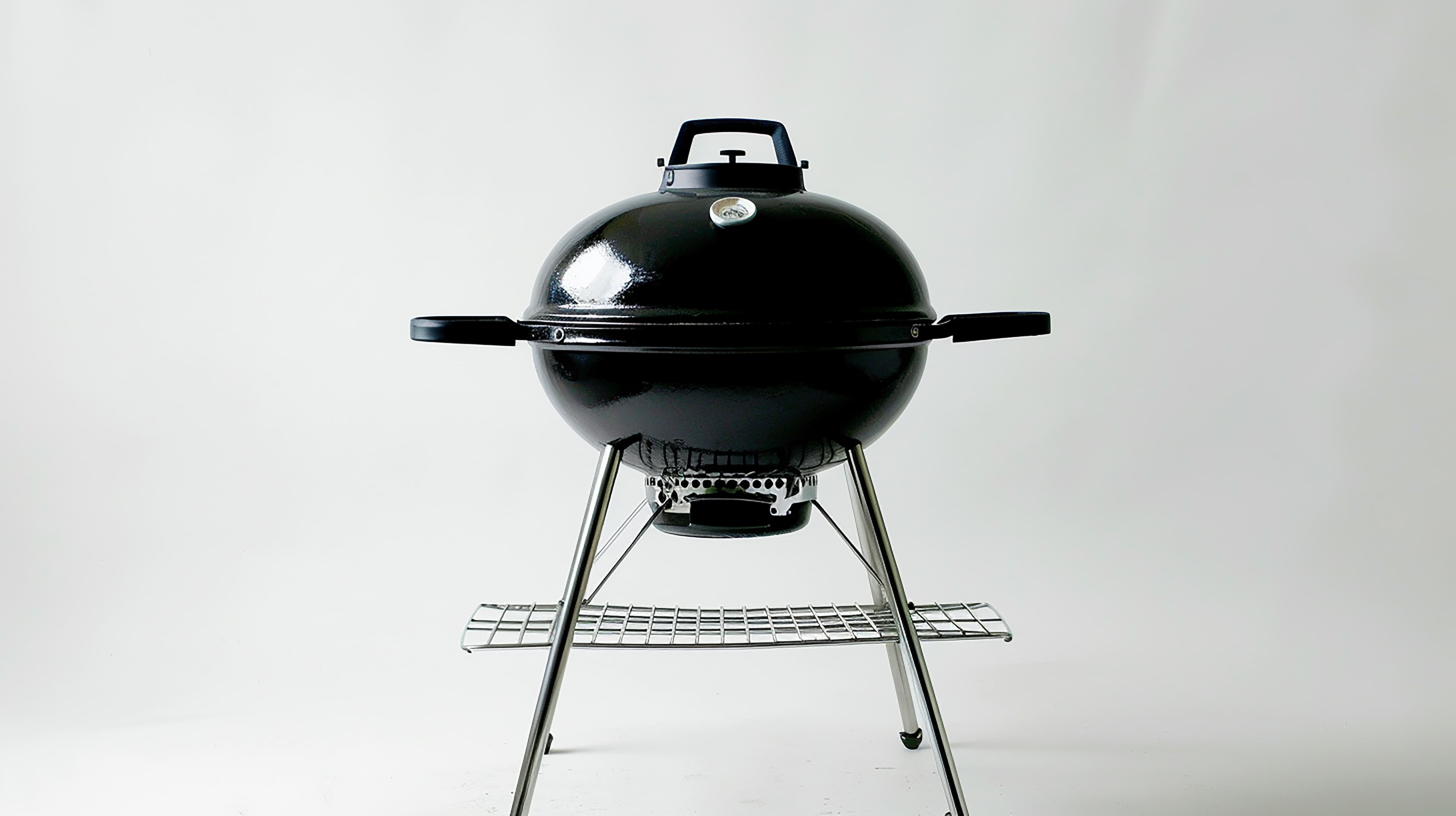 A black charcoal BBQ grill for gas and charcoal grill sales at Aurora Home Hardware Building Centre.