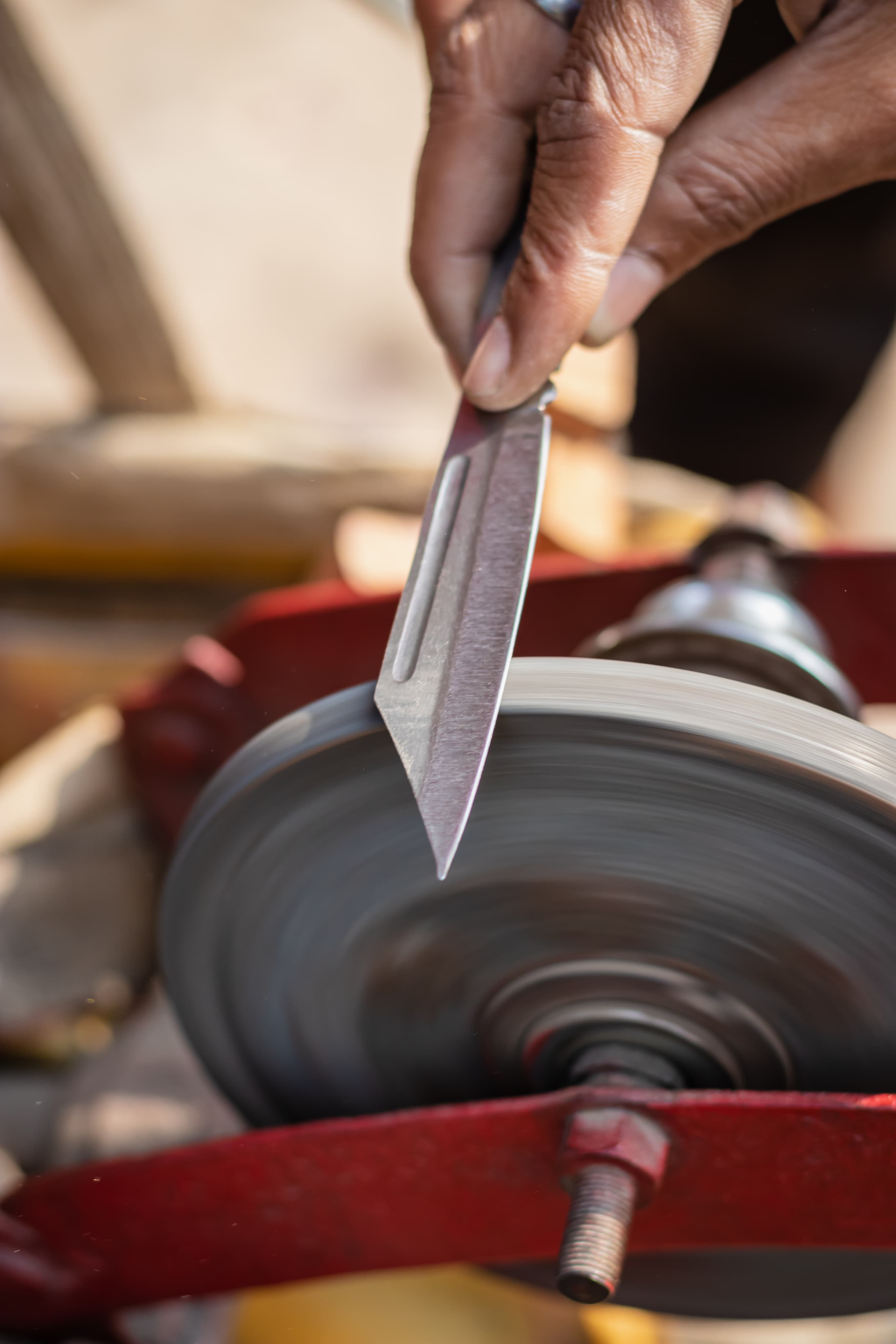 A blade being sharpened on a grinding wheel at Aurora Home Hardware Building Centre.