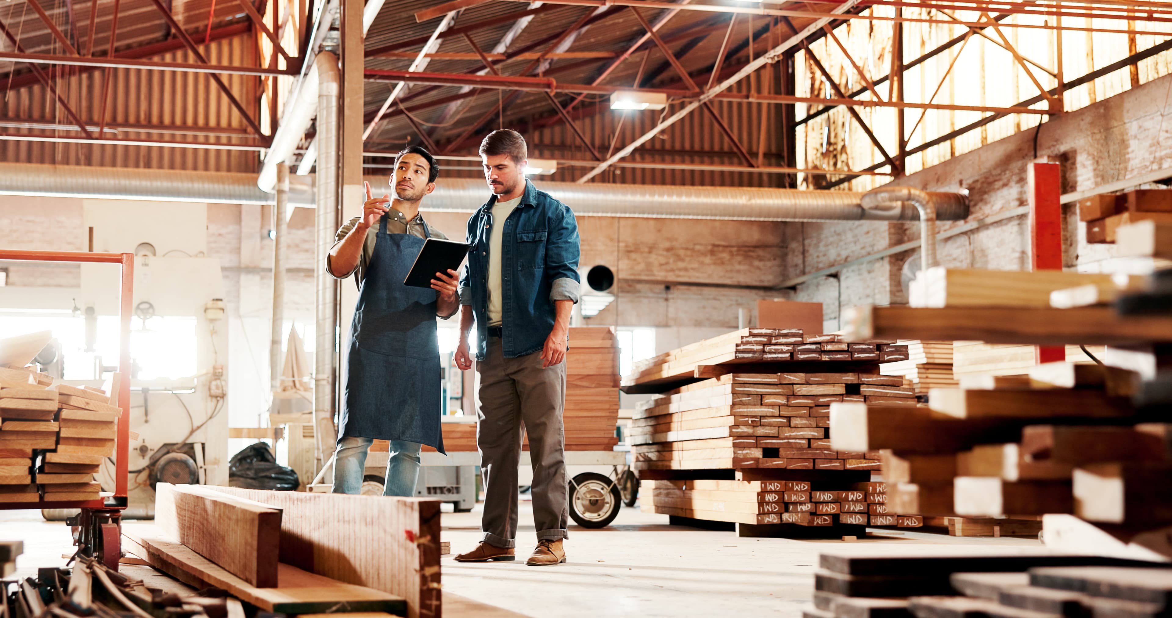 Staff assisting a customer in a lumber warehouse at the full-service lumber yard of Aurora Home Hardware Building Centre.